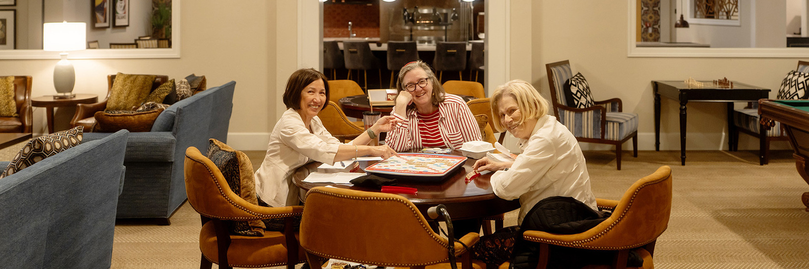 People sitting at a table playing scrabble. People sitting at a table playing scrabble.
