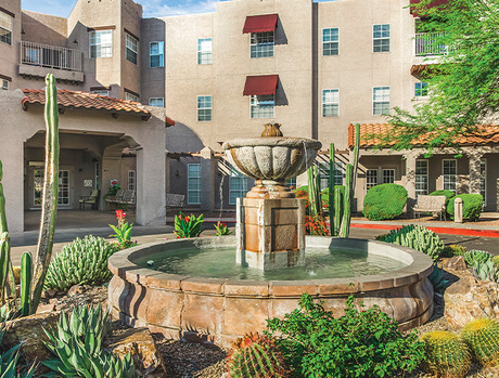 A building with a fountain in front.