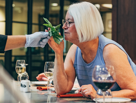 A resident is in a cooking class.