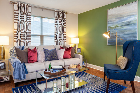 Furnished living room space with sofa, table, and seating area.