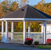 Gazebo surrounded by bushes.