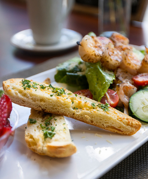 Toasted bread with shrimp on plate.