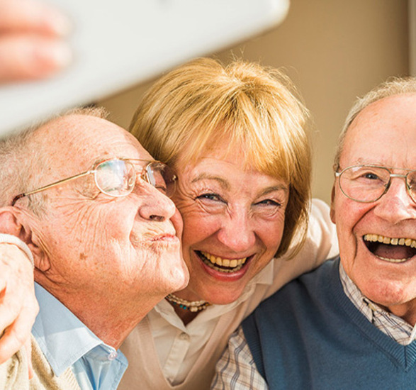 Three people taking a photo together.