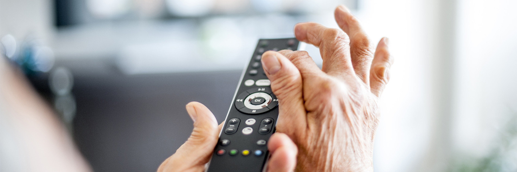 Hands managing a remote control. Hands managing a remote control.