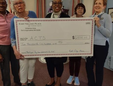 People holding large check with $2,500 donation.