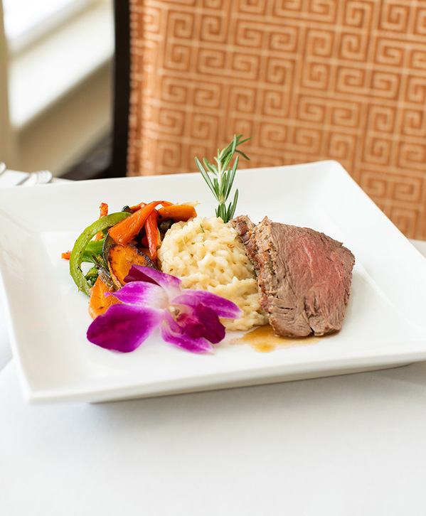Accordion image A plate with steak and vegetables on it.