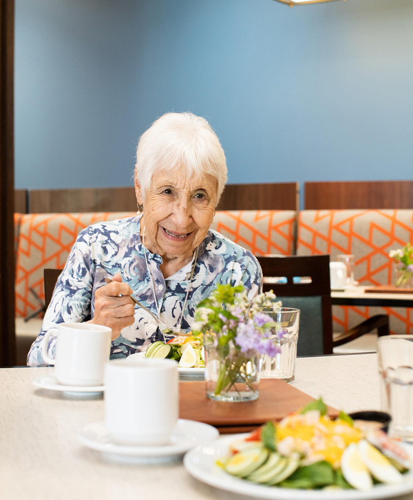 Two residents enjoying a meal together.