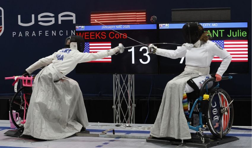 Two people are fencing in the Paralympics.
