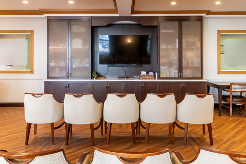 A theater or media room with chairs and a large tv.