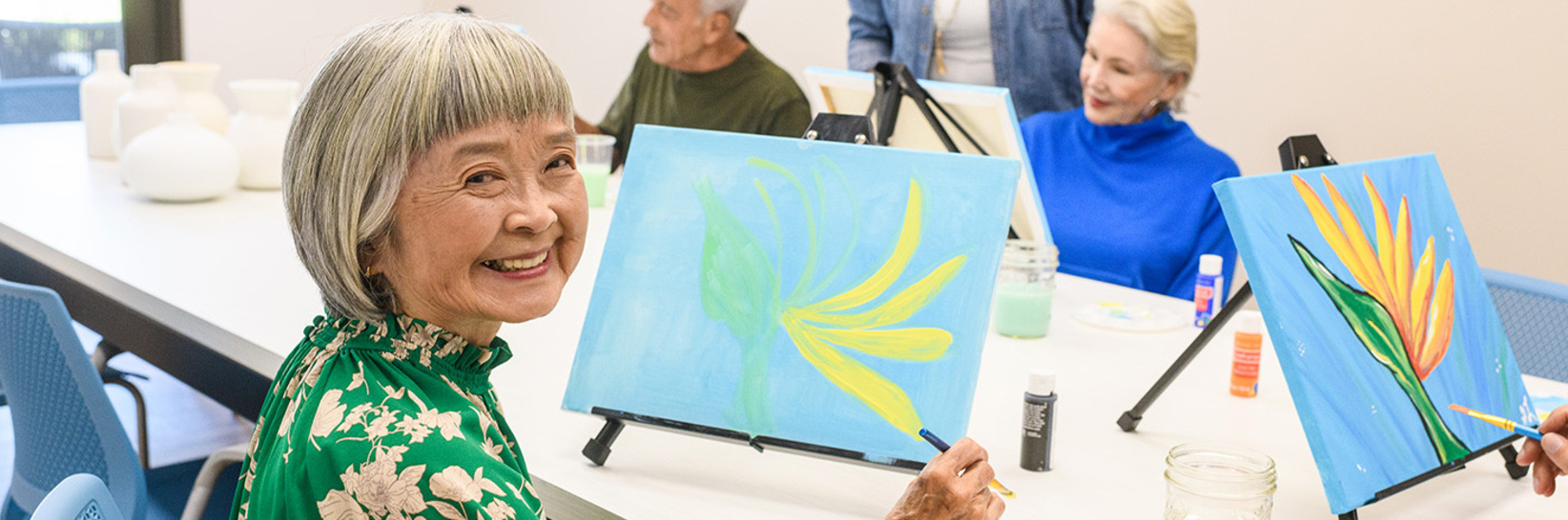 A group of residents painting. A group of residents painting.