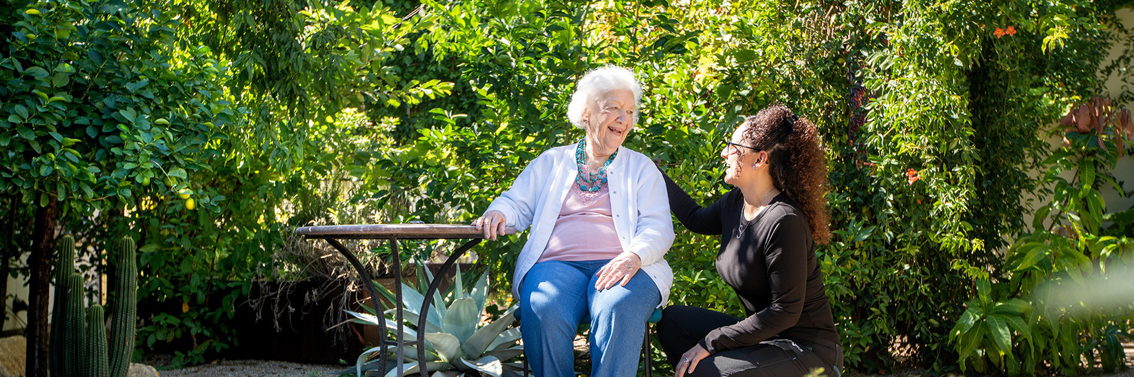 A resident with their caregiver at The Hacienda at The Canyon Memory Care Community in Tucson, AZ.