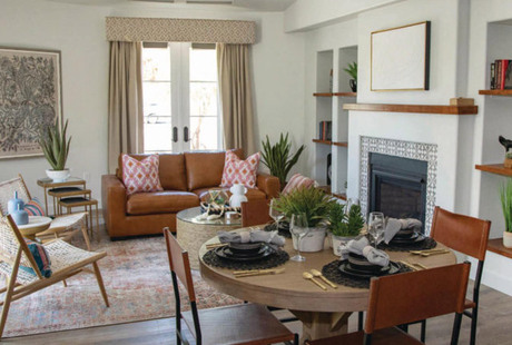 Furnished living room space with sofa, table, and seating area.