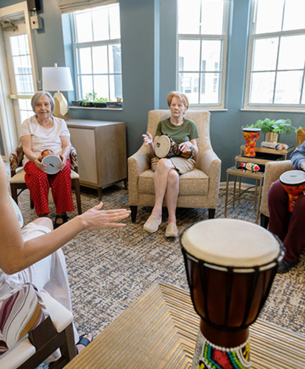 People participating in a drumming class. People participating in a drumming class.