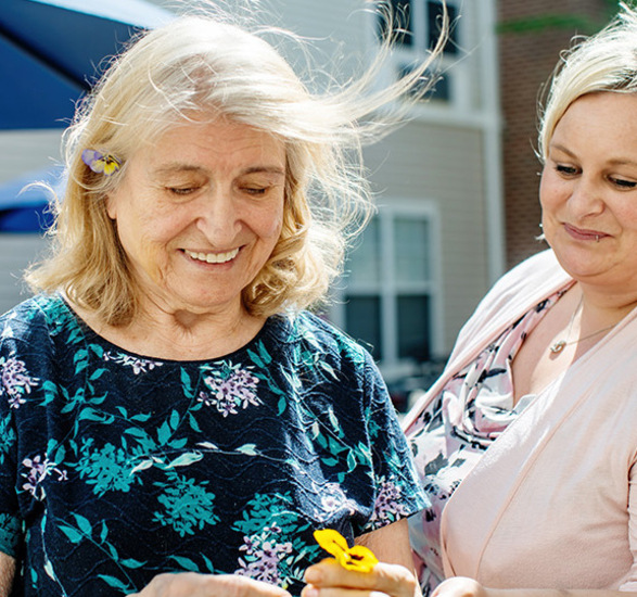 Two people looking at a flower.