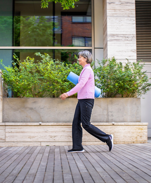 Accordion image A person walking to yoga class.