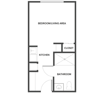 An assisted living studio floor plan with an open living/bedroom space.