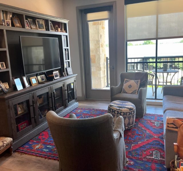 TV and two chairs in a living room.