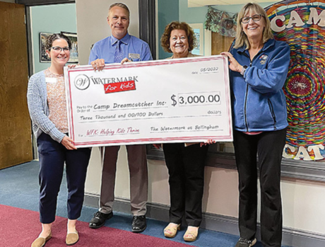 Four people holding check for Camp Dreamcatcher