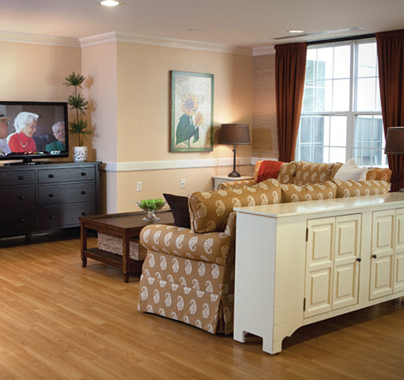 Furnished living room space with sofa, table, and seating area.