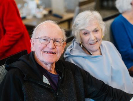Two members smiling at camera.