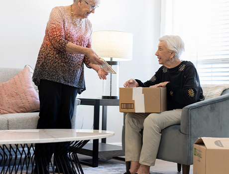 Two people packing boxes.