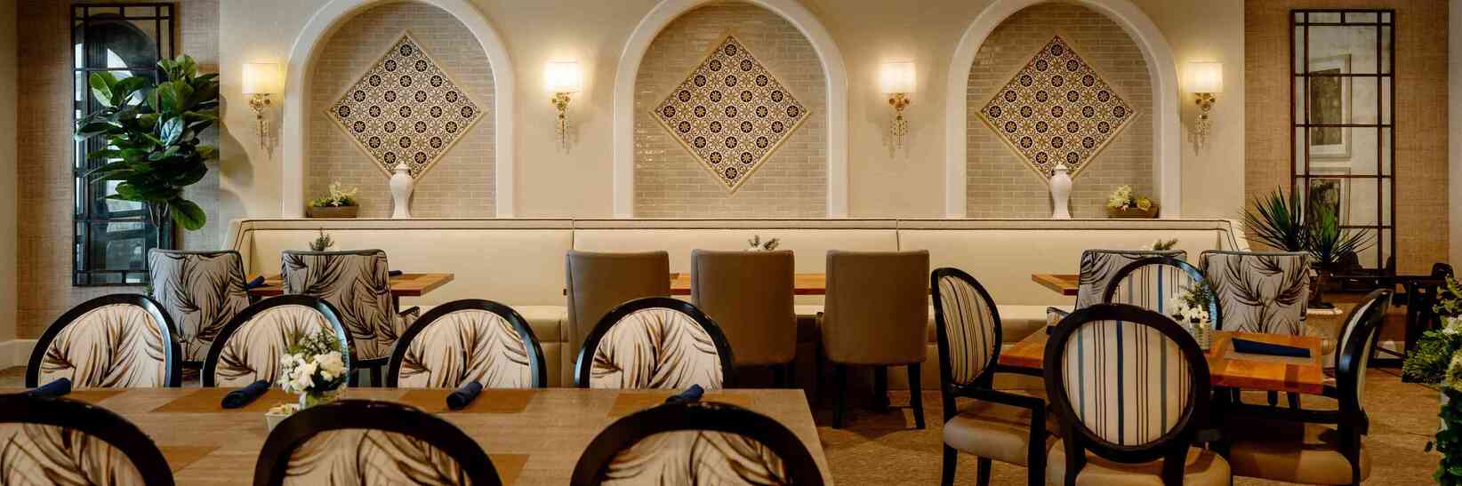 Restaurant with elegant tables and chairs at The Hacienda Mission San Luis Rey. Restaurant with elegant tables and chairs at The Hacienda Mission San Luis Rey.