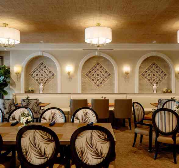 Restaurant with elegant tables and chairs at The Hacienda Mission San Luis Rey.