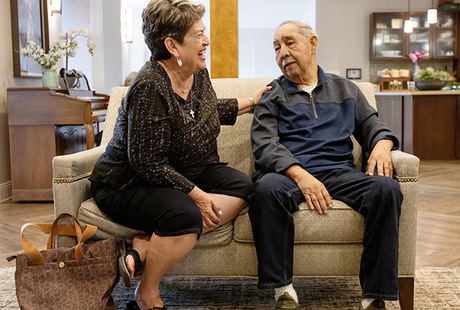 A resident and his wife on the couch.