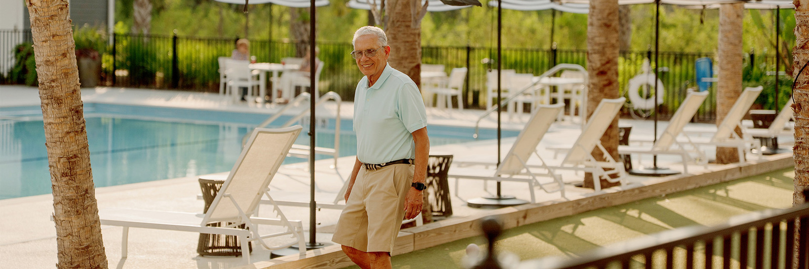 A person walking outside Water Sound Fountains, a retirement living community in Inlet Beach, FL. A person walking outside Water Sound Fountains, a retirement living community in Inlet Beach, FL.