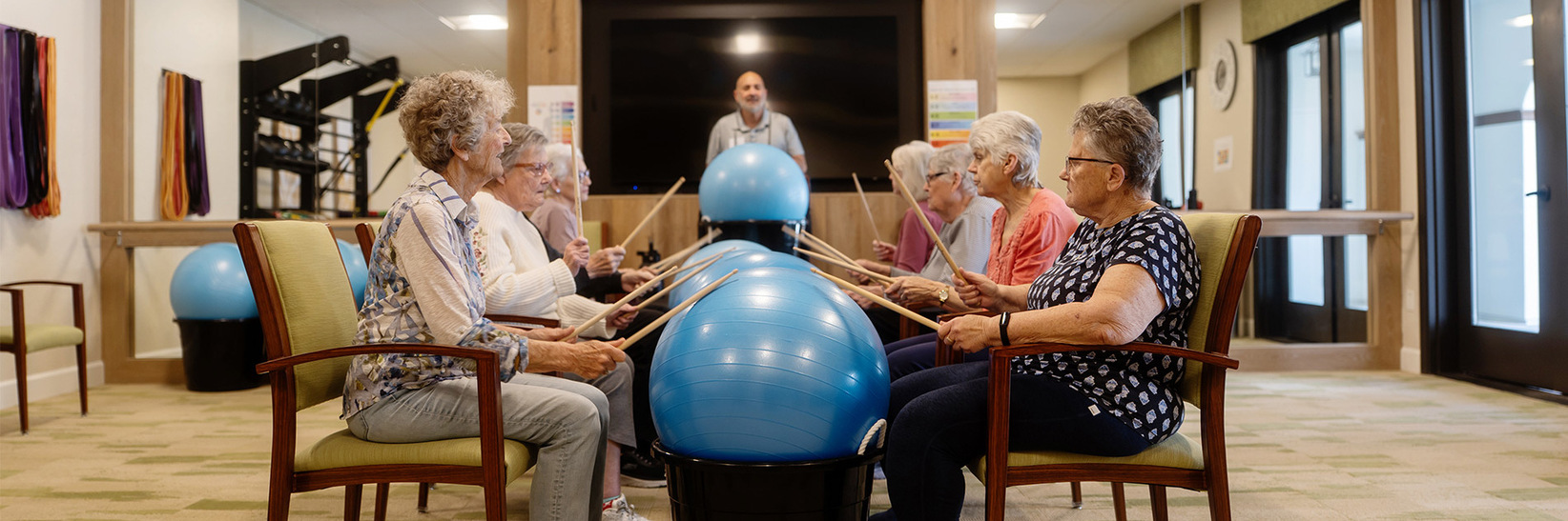 People hitting balls with drum sticks. People hitting balls with drum sticks.