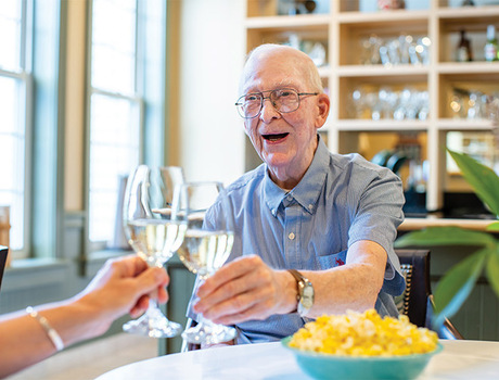 Two people toasting with wine.