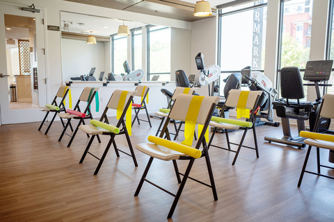 A fitness room with chairs.