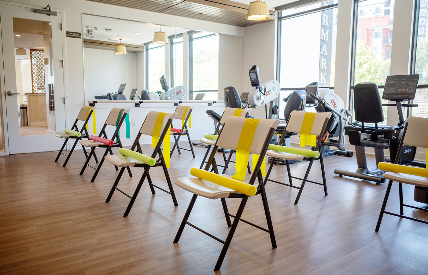 A fitness room with chairs.