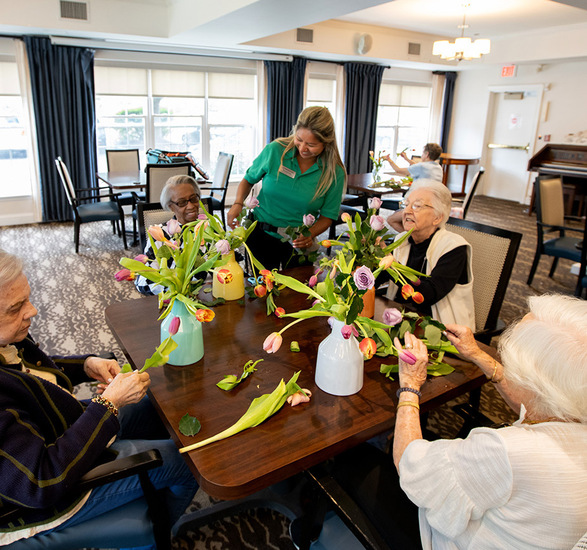 People at a table arranging flowers.