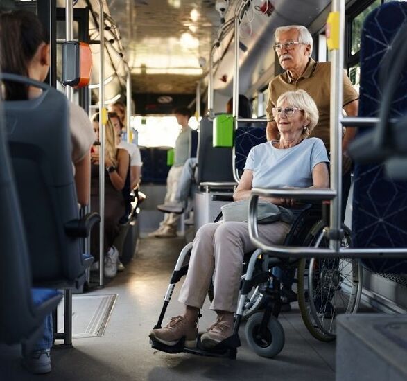 A women is in a wheelchair on a bus.