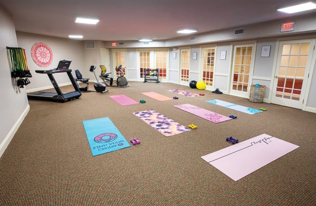 yoga mats on floor in fitness room 