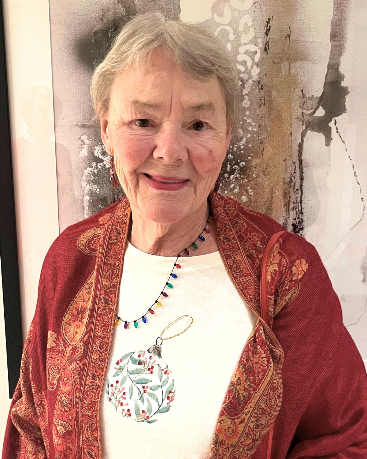 Person standing in front of a painting.