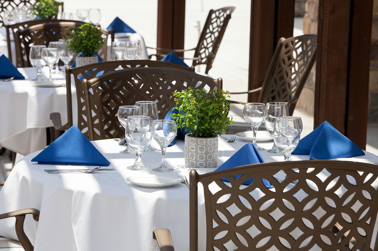 Table with blue napkins and chairs.