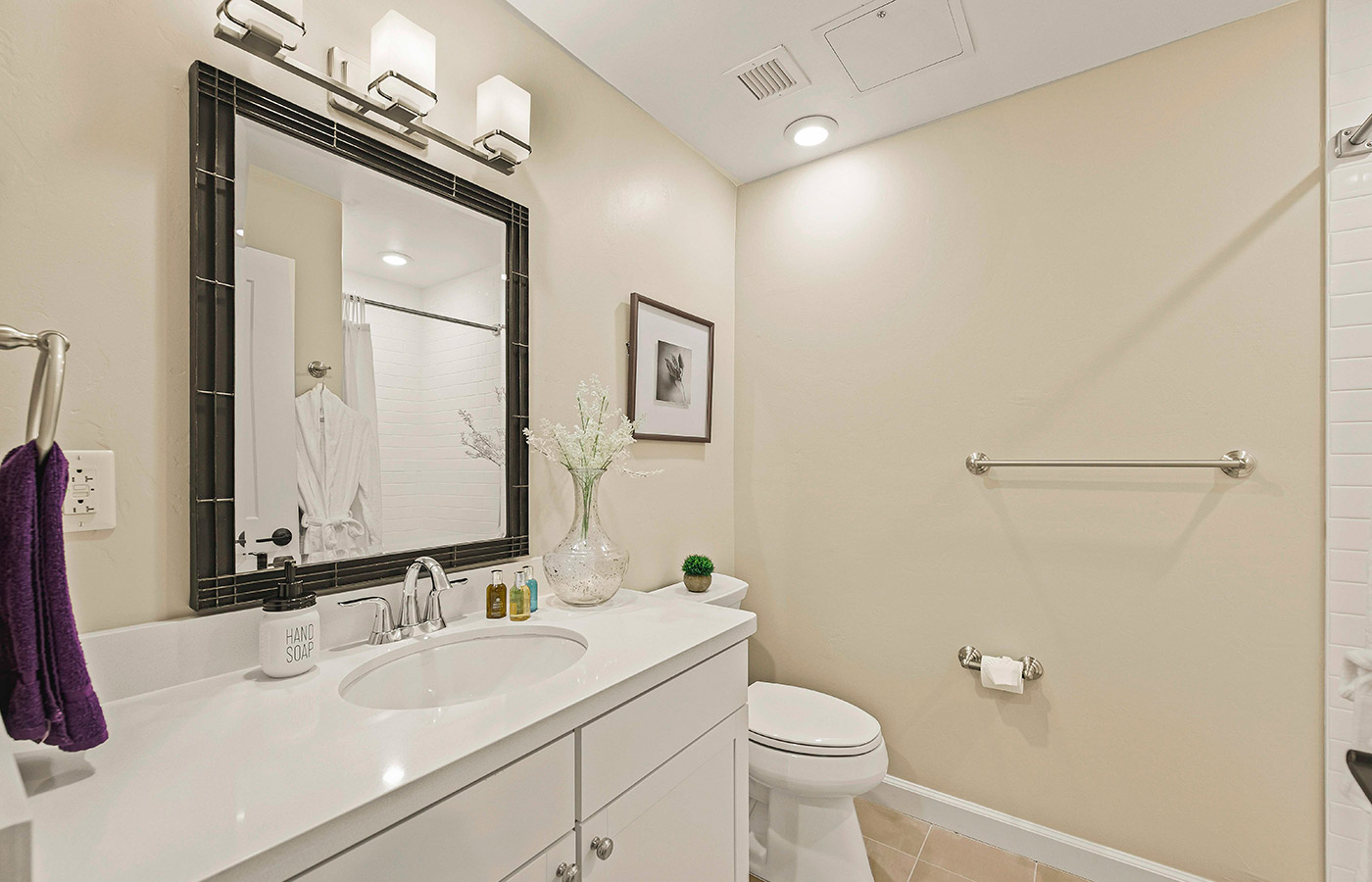 Bathroom with shower, toilet, and sink.