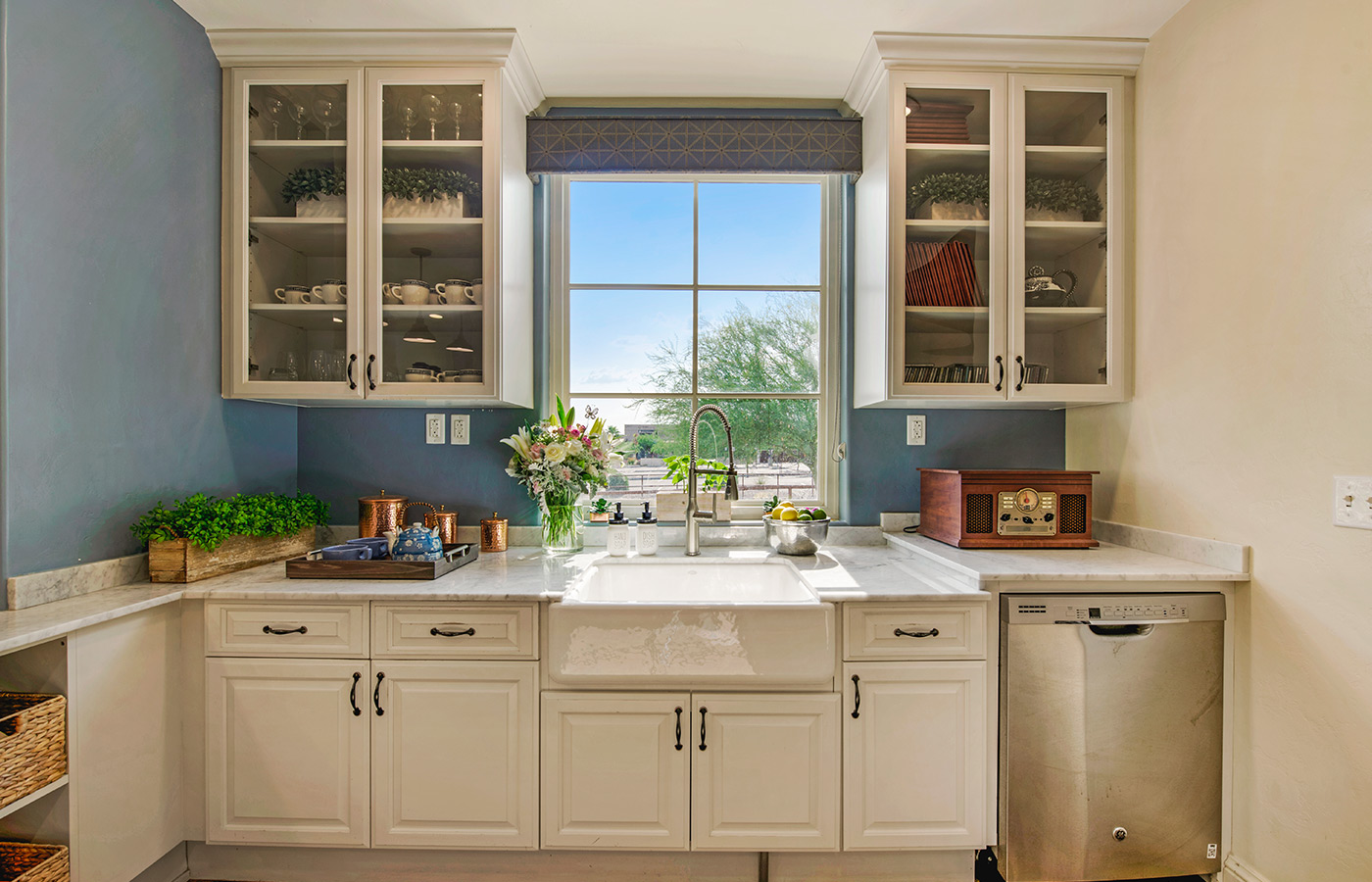 Kitchen cabinets with window and sky view.