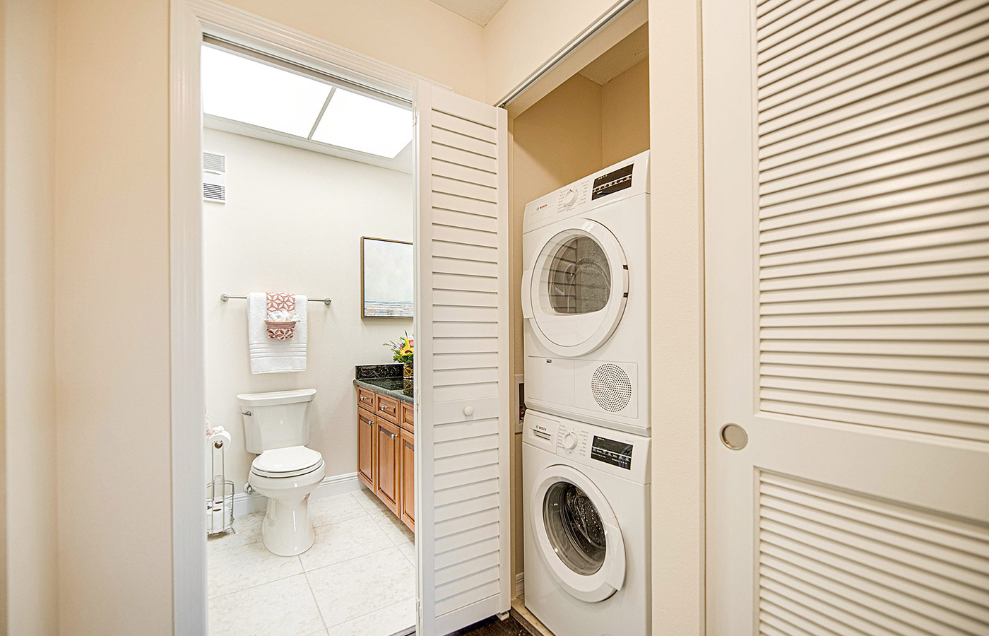washer and dryer next to the bathroom within unit