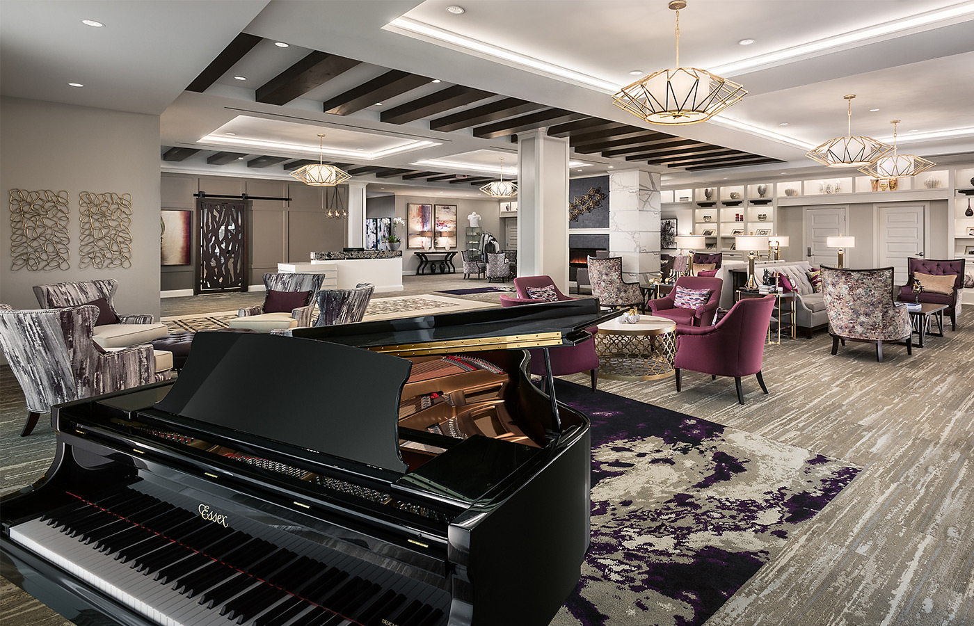 Seating lounge area with a black baby grand piano.