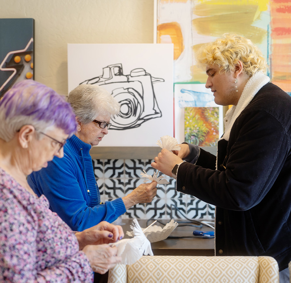 A person helping others with crafts.