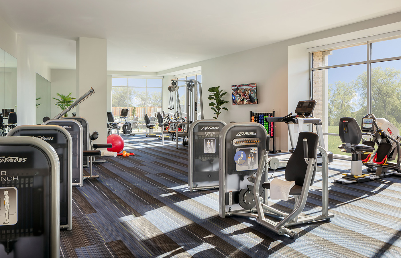 A large fitness center with exercise equipment.