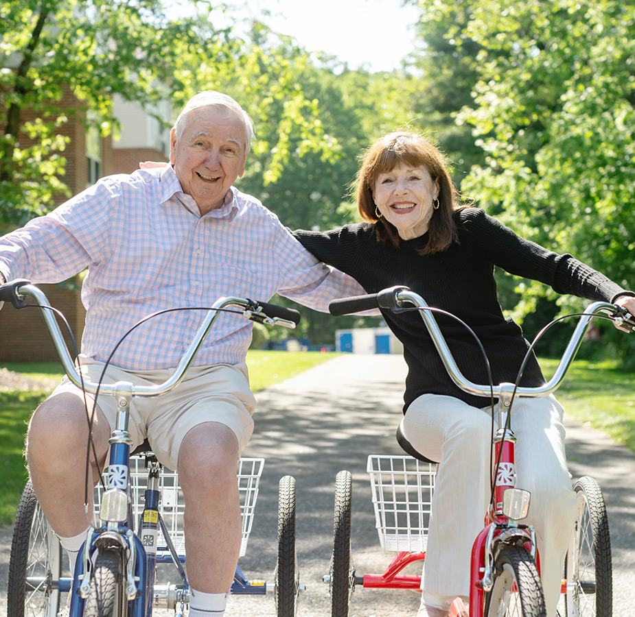 Two people riding bikes.