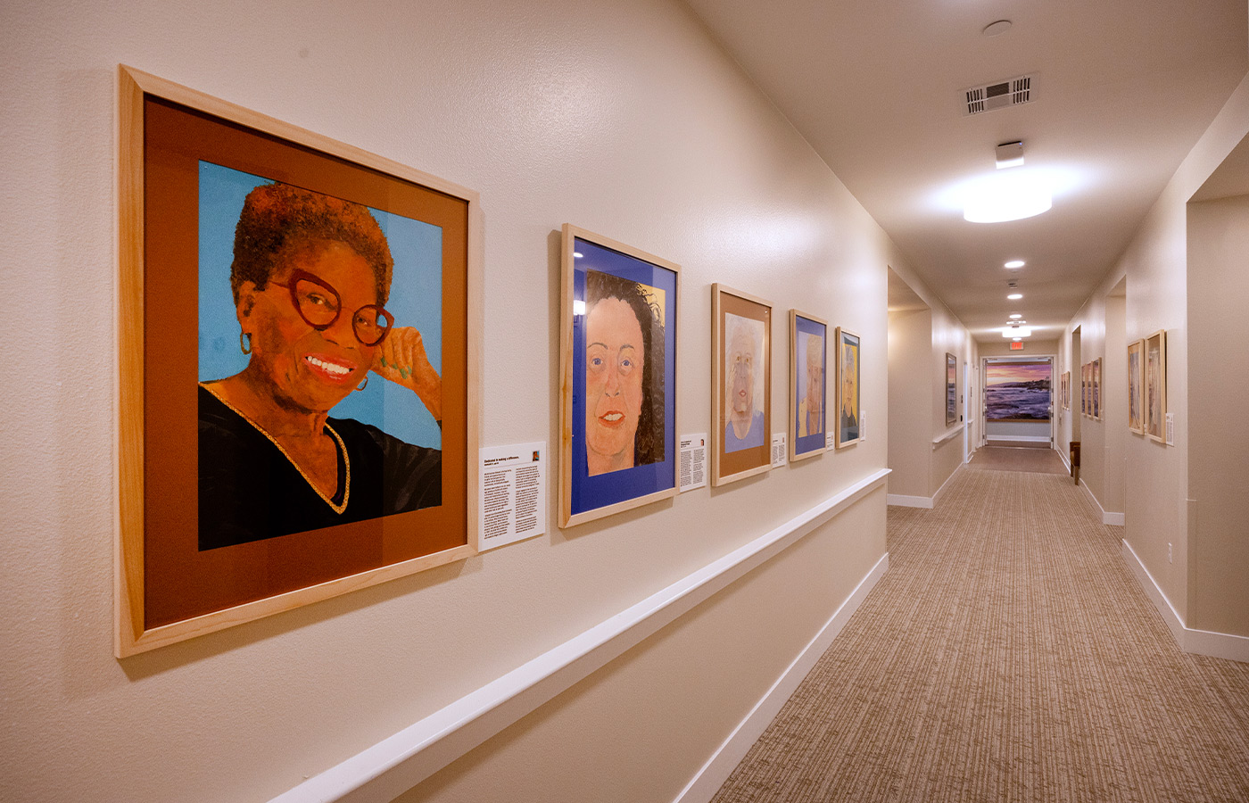 A hallway with paintings on the wall.