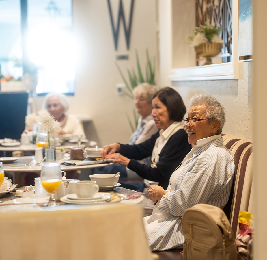 People sitting and eating breakfast.