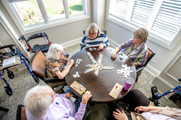 A group of residents sitting around a table playing a game.