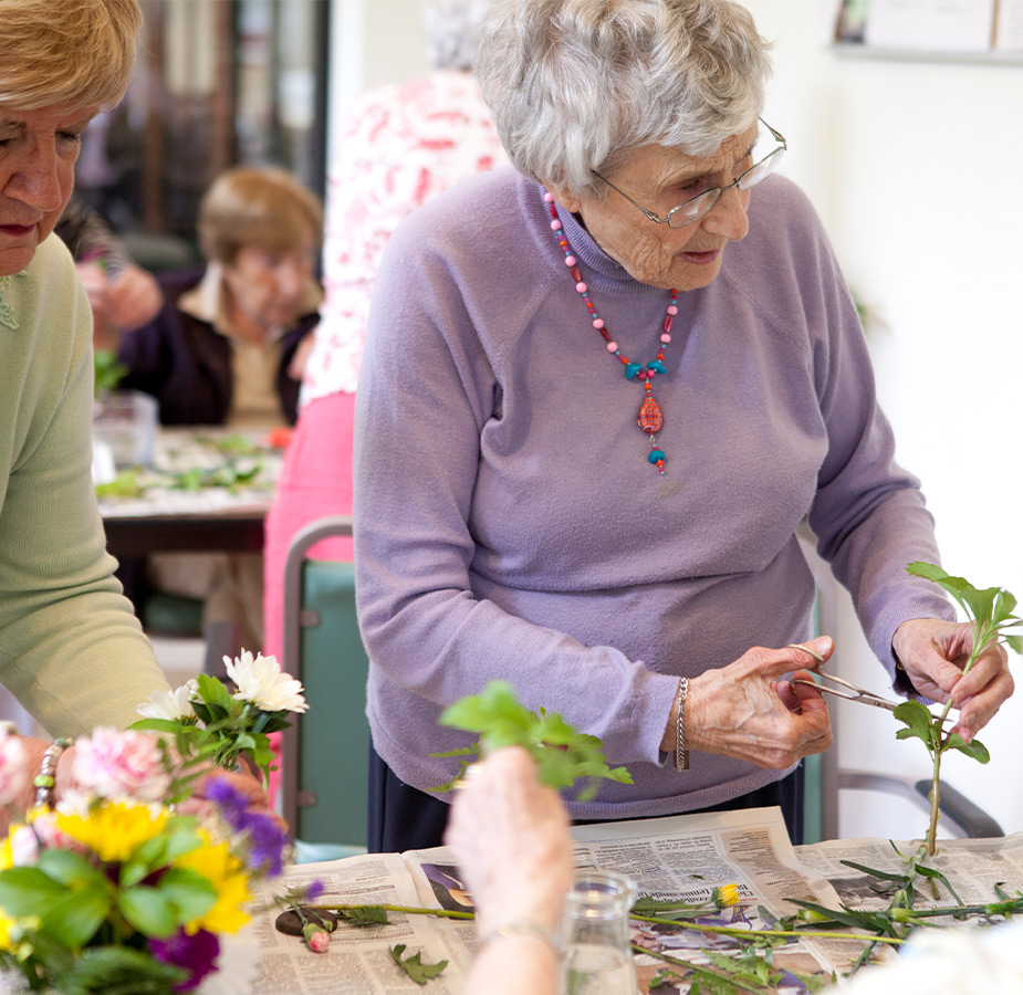 People in a floral arrangement class.