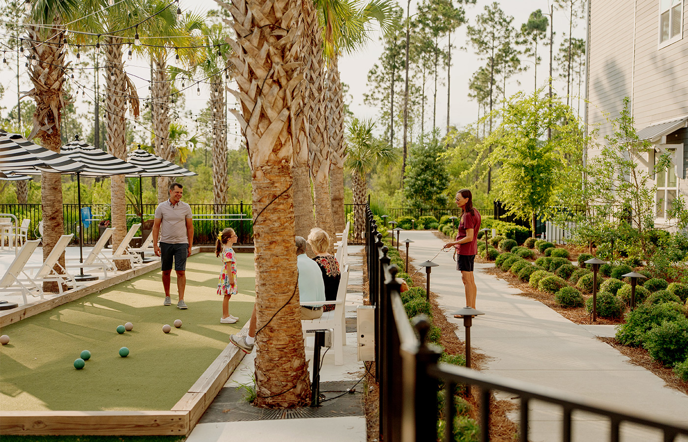 People outside on the bocce court.